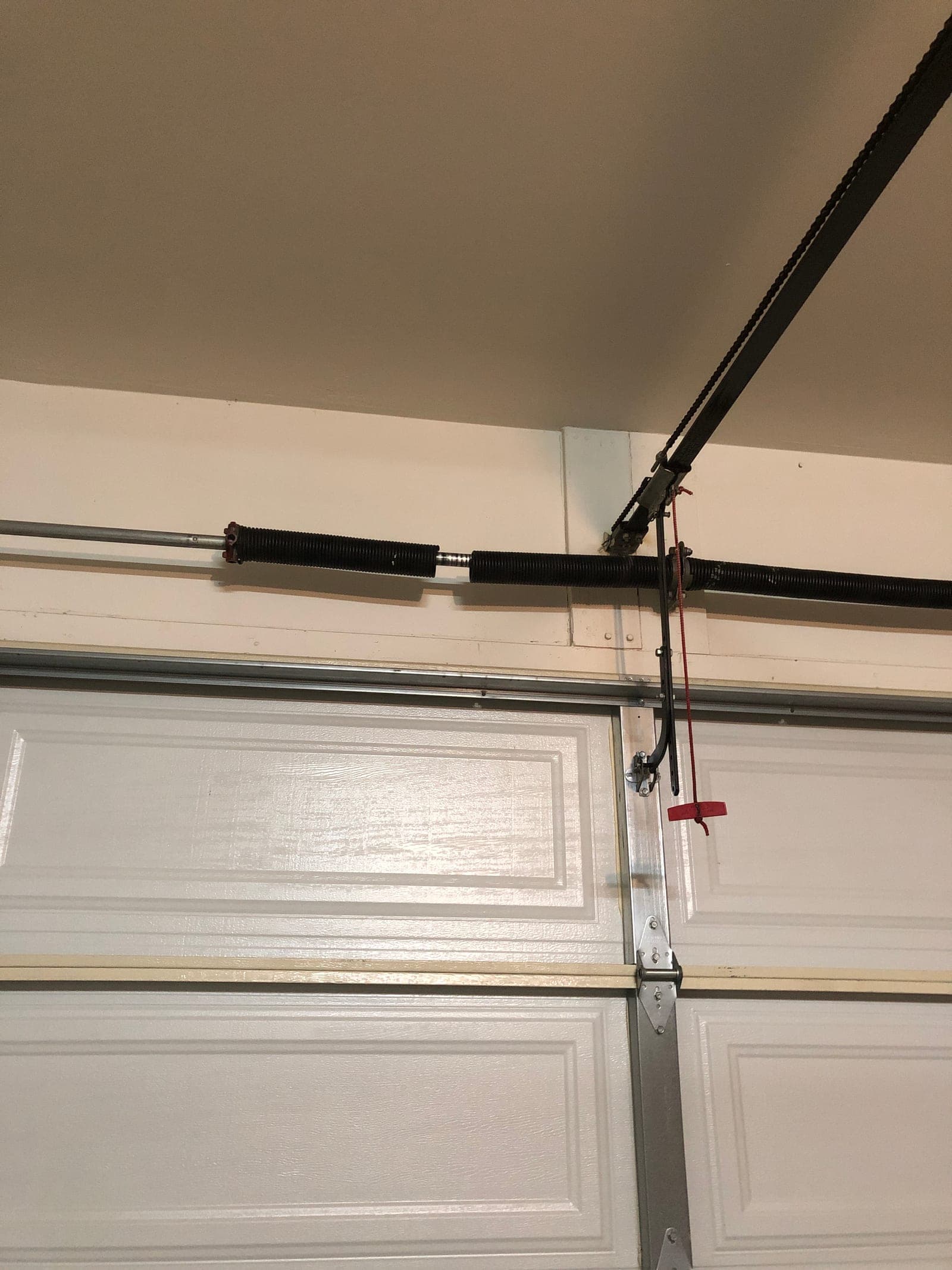 Torsion springs on the shaft during a State 48 broken garage door spring repair
