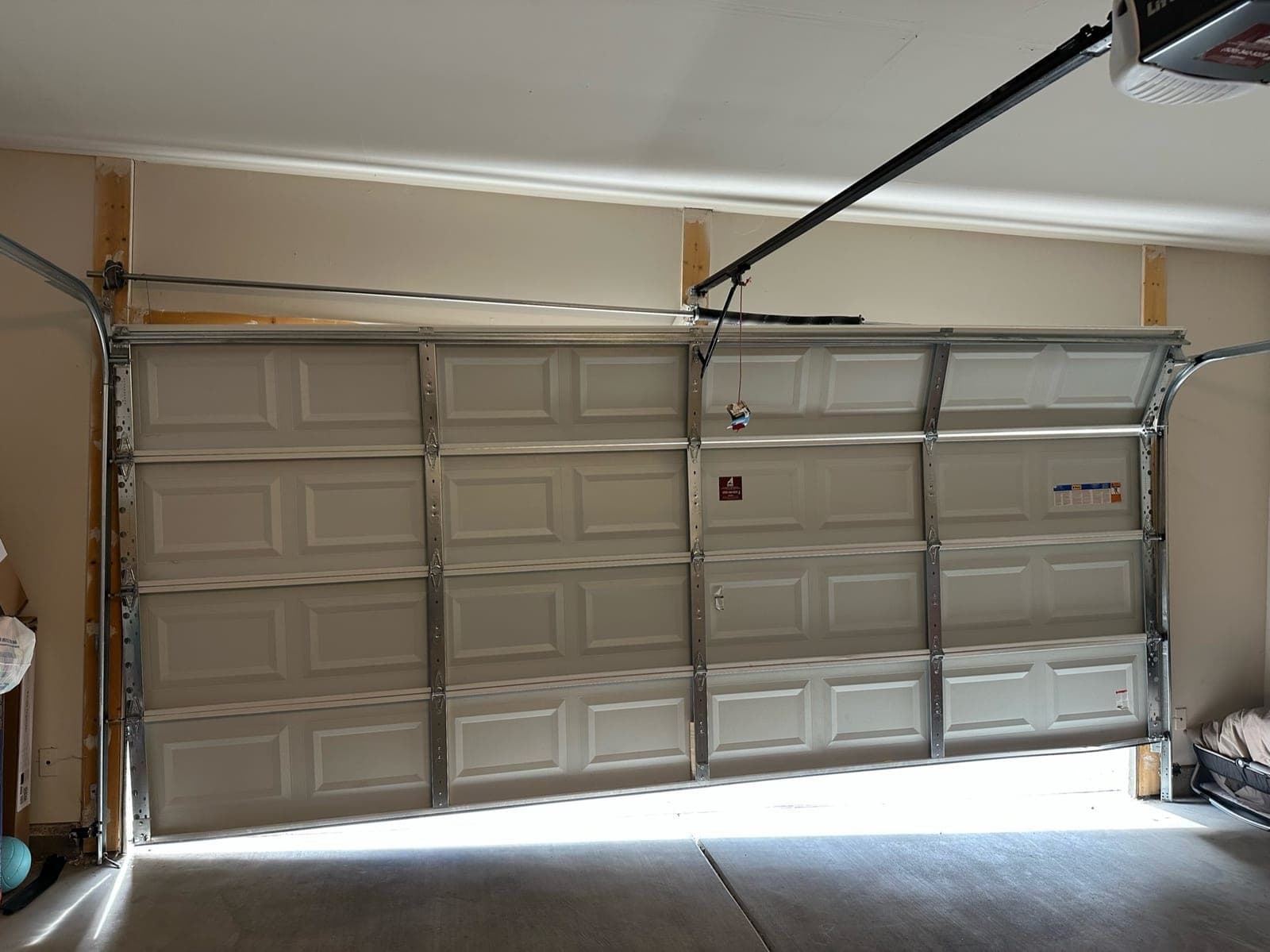 A garage door seated back on its tracks after a State 48 off-track repair